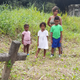 The author, right, with her son (left), daughter and nephew in a Trinidadian graveyard.